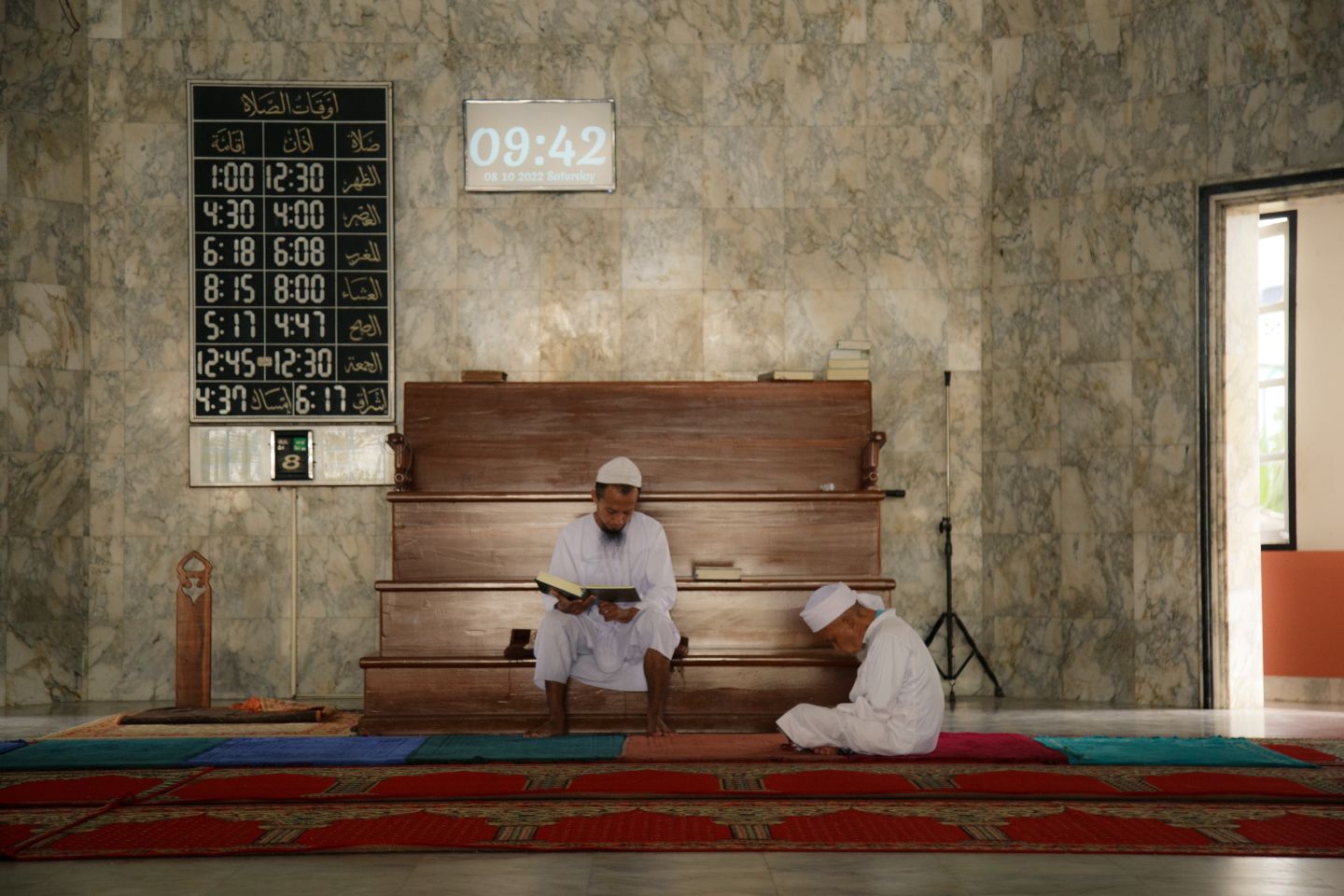 Men read the Qur'an at a mosque in Yala, Thailand.